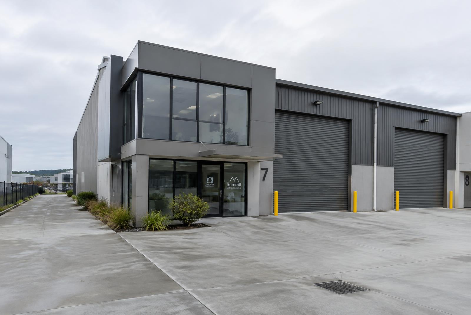 Modern warehouse with glazed office frontage and roller doors