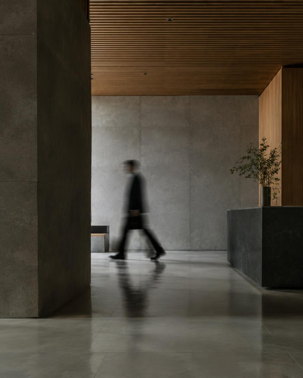 A person walking through an office lobby